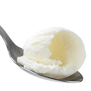Spoon with small shaving of ice cream.